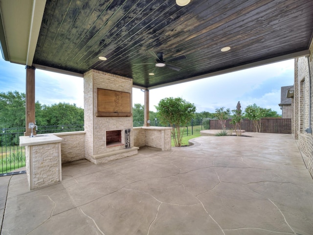 3509 Meridian Dr, Northlake, TX 76226 - fenced backyard with an outdoor stone fireplace, a ceiling fan, and a patio area