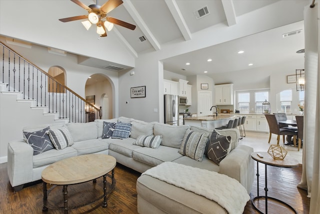 1430 Crescent Valley Dr, Prosper, TX 75078 - living room featuring arched walkways, high vaulted ceiling, ceiling fan, dark wood-style floors, and beamed ceiling