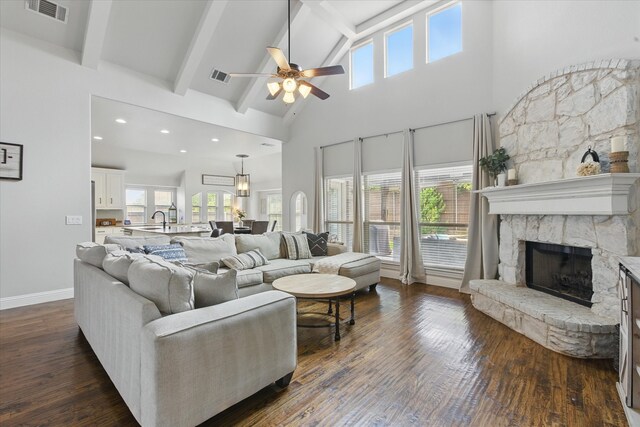1430 Crescent Valley Dr, Prosper, TX 75078 - living area featuring high vaulted ceiling, ceiling fan, a fireplace, beamed ceiling, and dark wood-style flooring