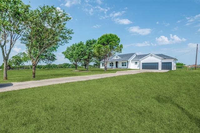 1450 W Fm 550, Mclendon Chisholm, TX 75032 - view of front of house with concrete driveway, a front lawn, a garage, and board and batten siding