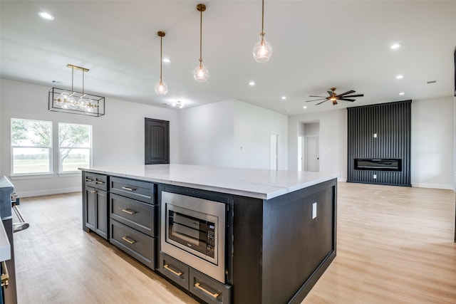 1450 W Fm 550, Mclendon Chisholm, TX 75032 - kitchen featuring stainless steel microwave, light wood finished floors, baseboards, ceiling fan, and recessed lighting