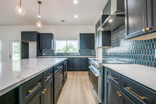 1450 W Fm 550, Mclendon Chisholm, TX 75032 - kitchen with high end stove, wall chimney exhaust hood, light wood-style flooring, decorative backsplash, and healthy amount of natural light