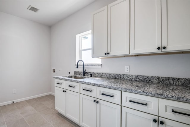 1450 W Fm 550, Mclendon Chisholm, TX 75032 - kitchen with a sink, baseboards, light stone counters, and white cabinetry