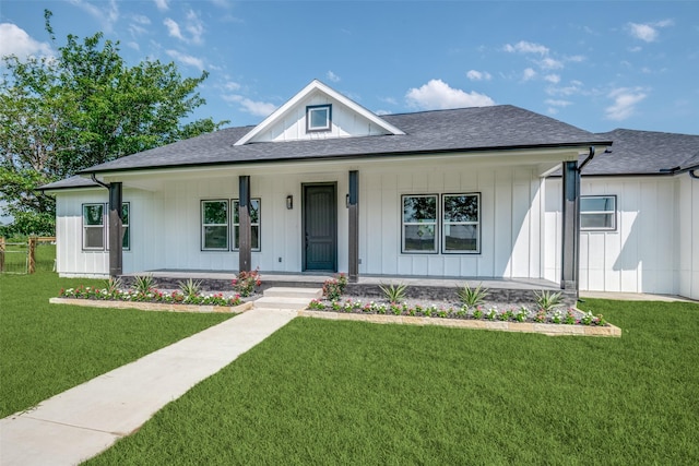 1450 W Fm 550, Mclendon Chisholm, TX 75032 - modern farmhouse style home with covered porch, a front lawn, a shingled roof, and board and batten siding