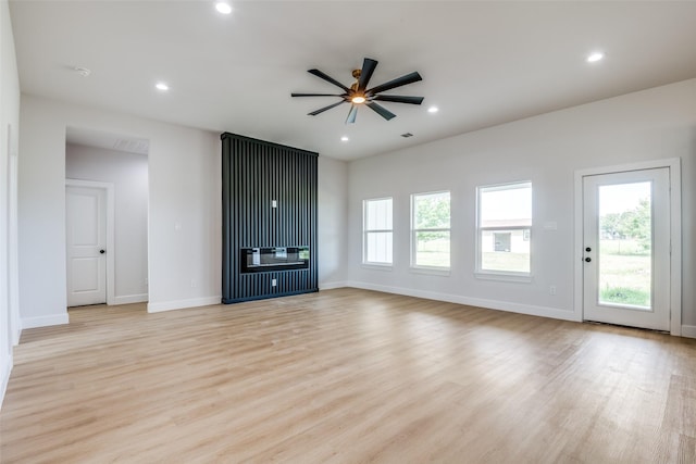 1450 W Fm 550, Mclendon Chisholm, TX 75032 - unfurnished living room featuring healthy amount of natural light, light wood finished floors, a ceiling fan, a fireplace, and recessed lighting