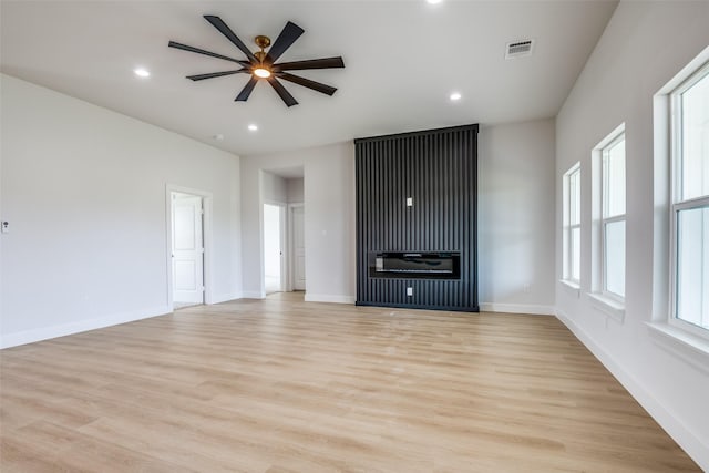 1450 W Fm 550, Mclendon Chisholm, TX 75032 - unfurnished living room with light wood-style floors, a ceiling fan, recessed lighting, baseboards, and a glass covered fireplace