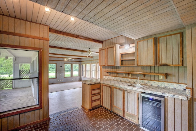 201 Brookhaven Ter, Commerce, TX 75428 - kitchen featuring beverage cooler, a sink, light brown cabinets, open shelves, and brick patterned floors