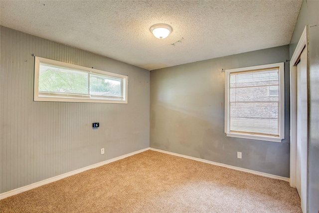 201 Brookhaven Ter, Commerce, TX 75428 - unfurnished room featuring carpet floors, baseboards, and a textured ceiling