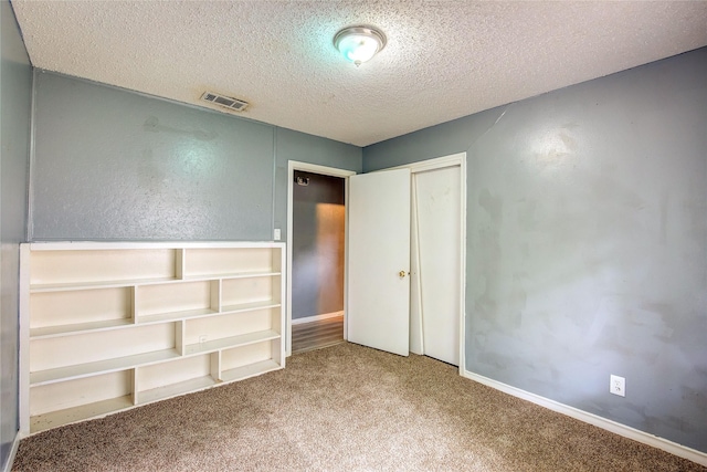 201 Brookhaven Ter, Commerce, TX 75428 - unfurnished bedroom with carpet floors, a textured ceiling, a closet, and baseboards
