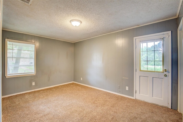 201 Brookhaven Ter, Commerce, TX 75428 - empty room featuring carpet, ornamental molding, a textured ceiling, and baseboards
