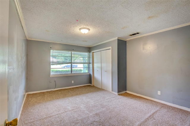 201 Brookhaven Ter, Commerce, TX 75428 - unfurnished bedroom featuring crown molding, a textured ceiling, carpet floors, a closet, and baseboards
