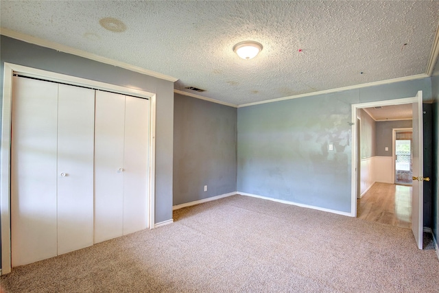 201 Brookhaven Ter, Commerce, TX 75428 - unfurnished bedroom with ornamental molding, carpet floors, a textured ceiling, a closet, and baseboards