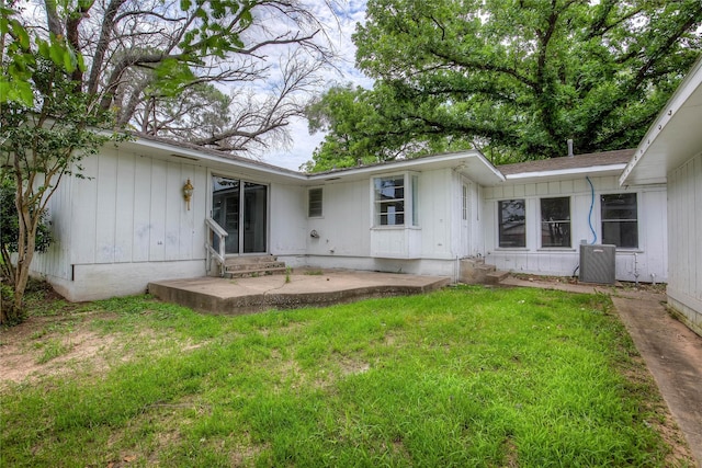 201 Brookhaven Ter, Commerce, TX 75428 - rear view of property with entry steps, a yard, a patio, and board and batten siding