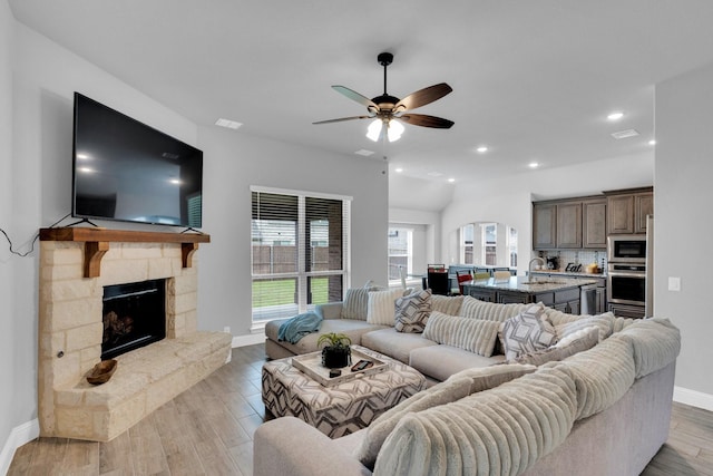 2417 Warrington Pl, Mansfield, TX 76084 - living area featuring ceiling fan, baseboards, a fireplace, light wood-type flooring, and recessed lighting