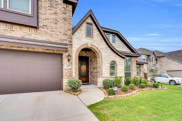2417 Warrington Pl, Mansfield, TX 76084 - view of front of property featuring a front yard, brick siding, concrete driveway, and a garage