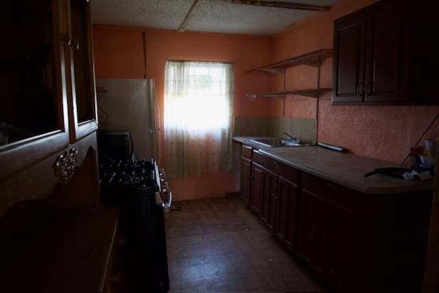3409 Reed St, Fort Worth, TX 76119 - kitchen with light countertops, a sink, light floors, freestanding refrigerator, and open shelves