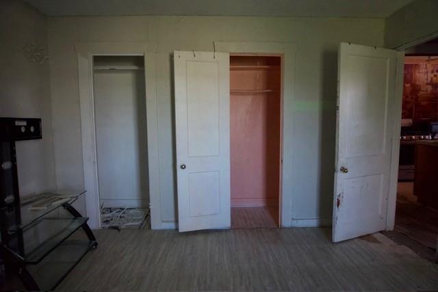 3409 Reed St, Fort Worth, TX 76119 - unfurnished bedroom featuring wood finished floors