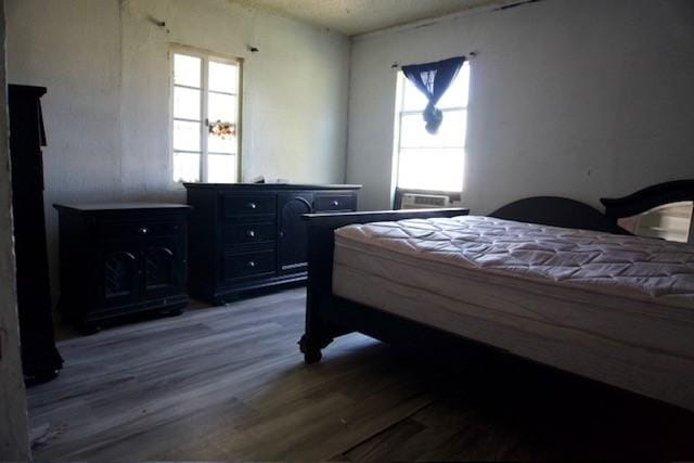 3409 Reed St, Fort Worth, TX 76119 - bedroom featuring wood finished floors and multiple windows