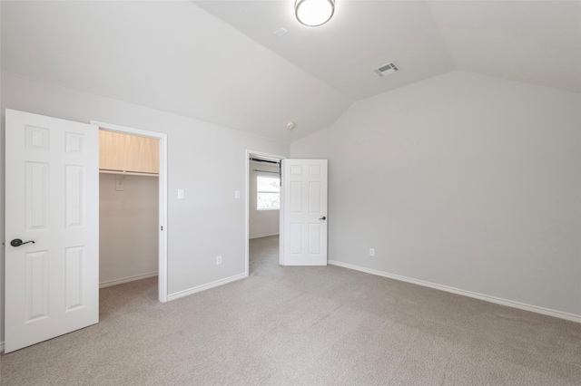 1605 Tanglewood Dr, Allen, TX 75002 - unfurnished bedroom with vaulted ceiling, light carpet, a walk in closet, baseboards, and a closet