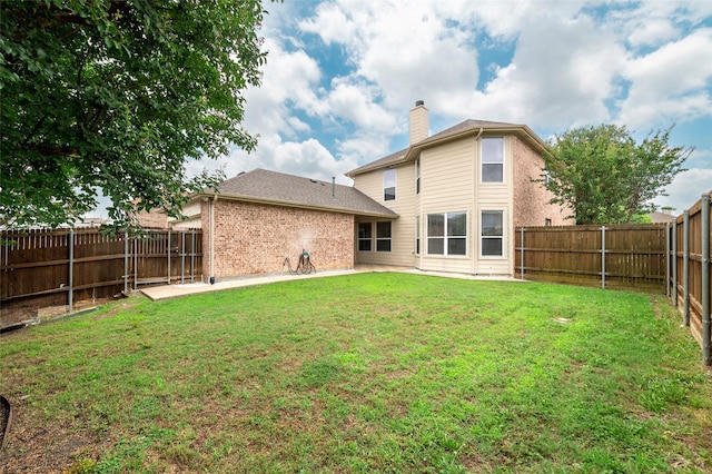 1605 Tanglewood Dr, Allen, TX 75002 - back of property with a patio area, a chimney, and brick siding