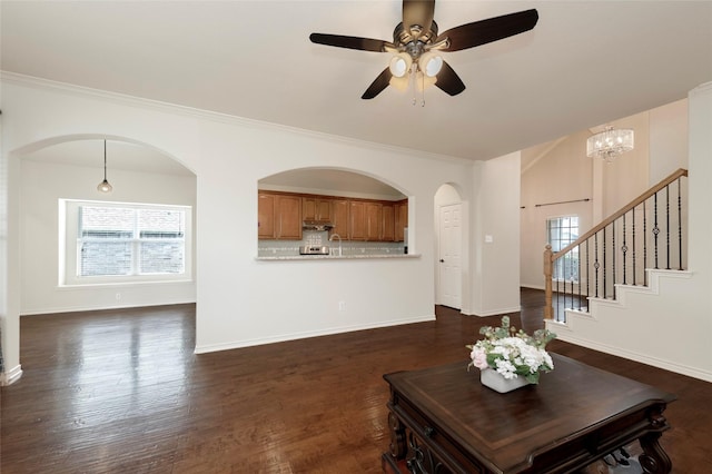 1605 Tanglewood Dr, Allen, TX 75002 - living room featuring a ceiling fan, dark wood-type flooring, crown molding, and stairway