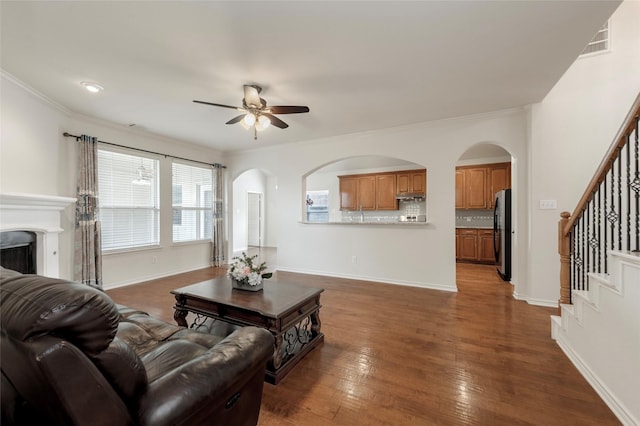 1605 Tanglewood Dr, Allen, TX 75002 - living area with a ceiling fan, stairway, hardwood / wood-style flooring, arched walkways, and ornamental molding