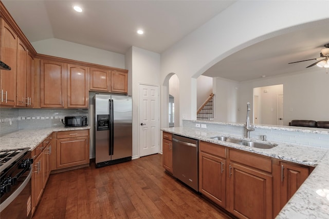1605 Tanglewood Dr, Allen, TX 75002 - kitchen featuring stainless steel appliances, light stone countertops, tasteful backsplash, arched walkways, and recessed lighting