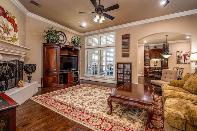 11626 Coronado Trl, Frisco, TX 75033 - living room featuring arched walkways, ornamental molding, a ceiling fan, dark wood-type flooring, and baseboards