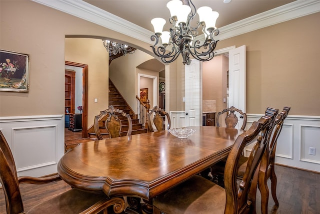 11626 Coronado Trl, Frisco, TX 75033 - dining room featuring arched walkways, crown molding, wainscoting, dark wood finished floors, and a decorative wall