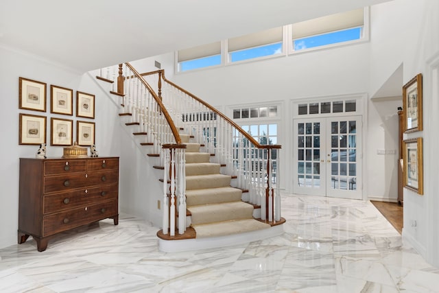 4417 Windsor Ridge Dr, Irving, TX 75038 - staircase featuring french doors, marble tiled floors, baseboards, and a towering ceiling