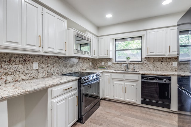 9502 Summerhill Ln, Dallas, TX 75238 - kitchen featuring dishwasher, range with electric stovetop, a sink, stainless steel microwave, and white cabinetry