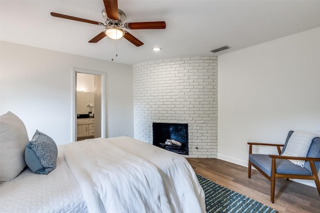 9502 Summerhill Ln, Dallas, TX 75238 - bedroom with wood finished floors, recessed lighting, a brick fireplace, ensuite bathroom, and baseboards