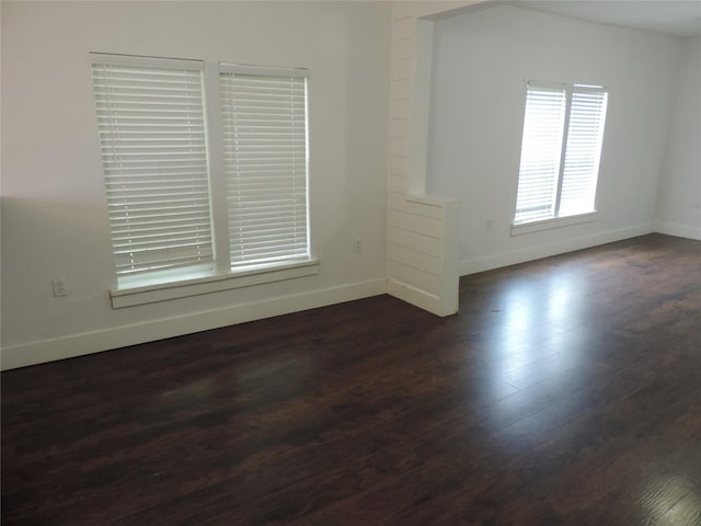622 N Race, Stephenville, TX 76401 - spare room featuring baseboards and dark wood-style floors
