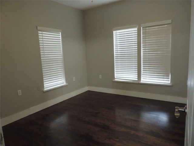 622 N Race, Stephenville, TX 76401 - spare room with dark wood finished floors, baseboards, and plenty of natural light