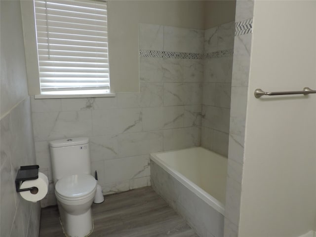 622 N Race, Stephenville, TX 76401 - bathroom featuring toilet, tile walls, and wood finished floors