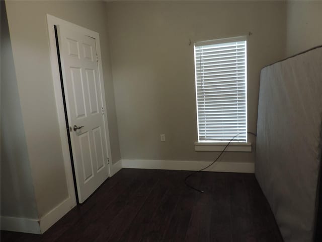 622 N Race, Stephenville, TX 76401 - unfurnished room with dark wood-type flooring and baseboards