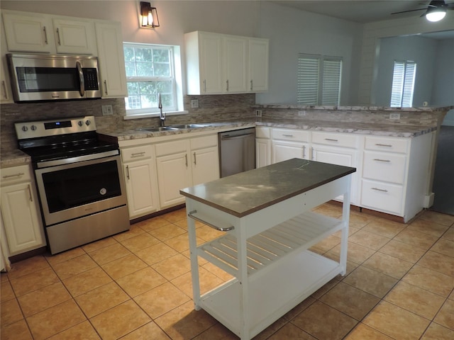 622 N Race, Stephenville, TX 76401 - kitchen with appliances with stainless steel finishes, a sink, plenty of natural light, and backsplash