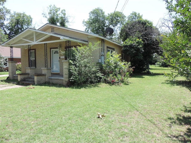 622 N Race, Stephenville, TX 76401 - view of front facade featuring brick siding, a front lawn, and covered porch