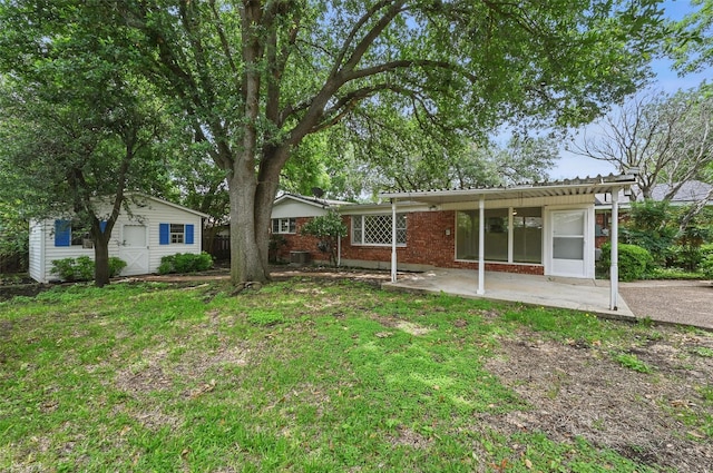 6729 Cylinda Sue Cir, North Richland Hills, TX 76180 - back of property with a patio, an outdoor structure, brick siding, and a yard