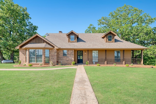 3893 E Fm 906, Powderly, TX 75473 - view of front facade with a front yard, covered porch, brick siding, and a shingled roof