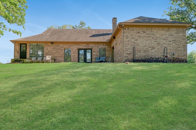 3893 E Fm 906, Powderly, TX 75473 - back of property featuring a chimney, a lawn, brick siding, and french doors