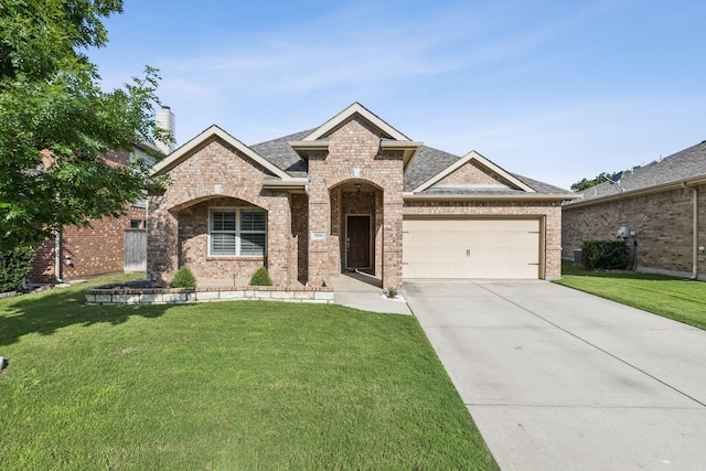 5016 Coney Island Dr, Frisco, TX 75036 - french country home with brick siding, an attached garage, a front lawn, and driveway
