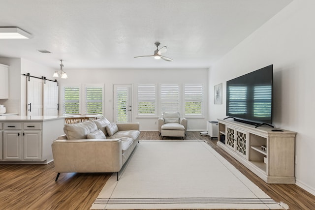 5016 Coney Island Dr, Frisco, TX 75036 - living room featuring wood finished floors, a barn door, plenty of natural light, and ceiling fan