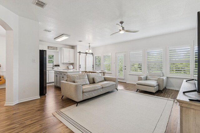5016 Coney Island Dr, Frisco, TX 75036 - living area with ceiling fan, wood finished floors, arched walkways, and baseboards