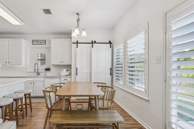 5016 Coney Island Dr, Frisco, TX 75036 - dining space featuring healthy amount of natural light, a barn door, and wood finished floors
