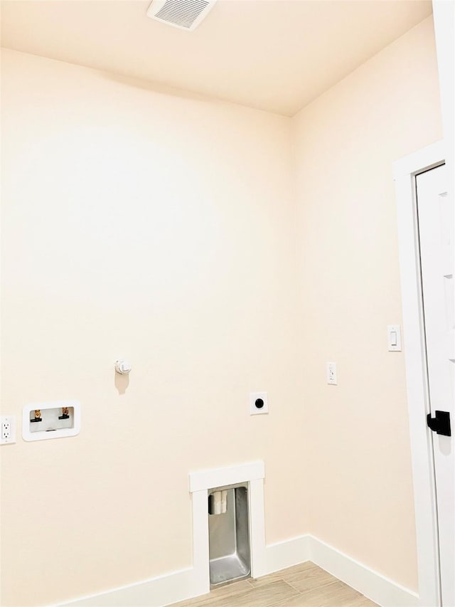 2309 Forest Hill Ln, Granbury, TX 76048 - laundry room with hookup for a washing machine, baseboards, hookup for an electric dryer, and light wood-type flooring