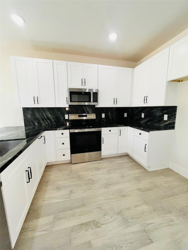 2309 Forest Hill Ln, Granbury, TX 76048 - kitchen with appliances with stainless steel finishes, decorative backsplash, white cabinets, dark countertops, and recessed lighting