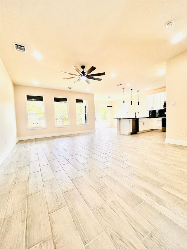 2309 Forest Hill Ln, Granbury, TX 76048 - unfurnished living room with recessed lighting, baseboards, a ceiling fan, and light wood-style floors