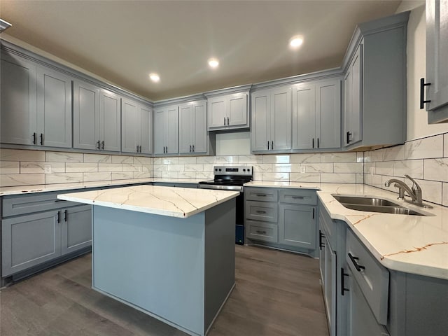 907 Davis St S, Sulphur Springs, TX 75482 - kitchen featuring stainless steel range with electric stovetop, gray cabinetry, a sink, dark wood finished floors, and decorative backsplash