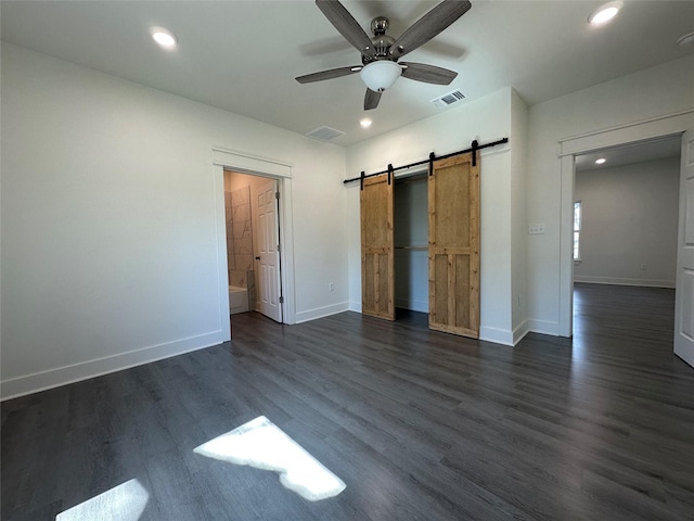 907 Davis St S, Sulphur Springs, TX 75482 - unfurnished bedroom with a barn door, baseboards, dark wood finished floors, recessed lighting, and a ceiling fan